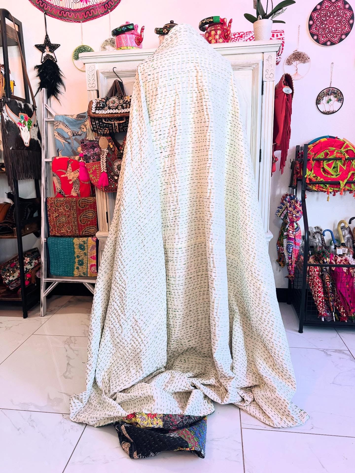 Solid white on the back show casing thousands of kantha stiches in colorful threads for this handamde kantha patchwork quilt