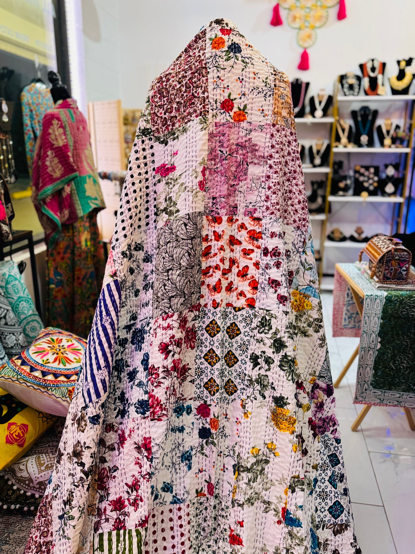 Close up look of some of the patches in silk patchwork kantha quilt with white background