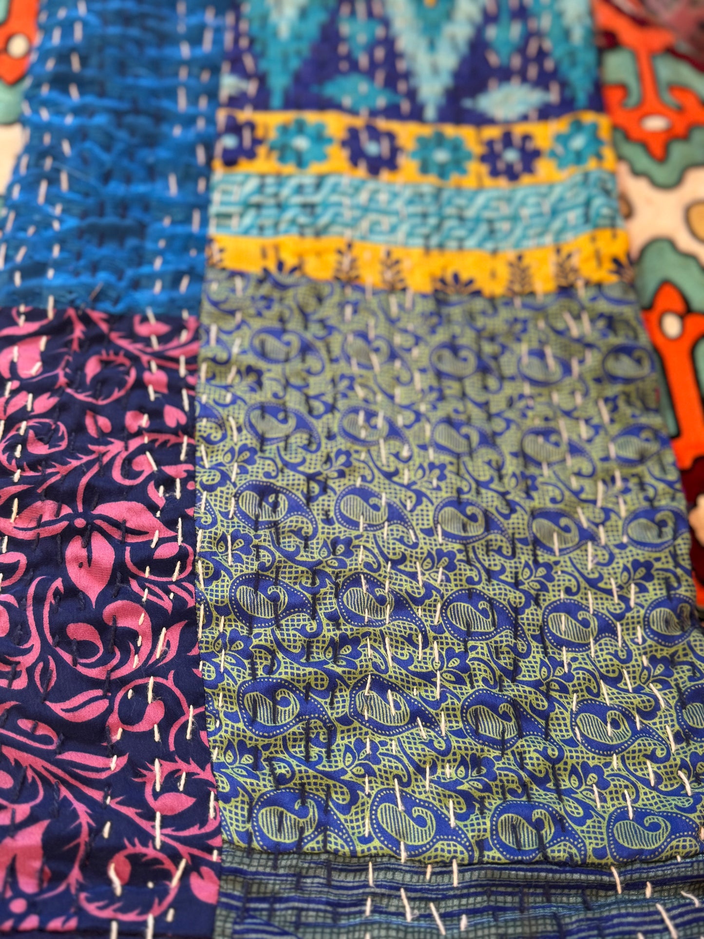 Close-up of patterned fabric with blue and pink designs