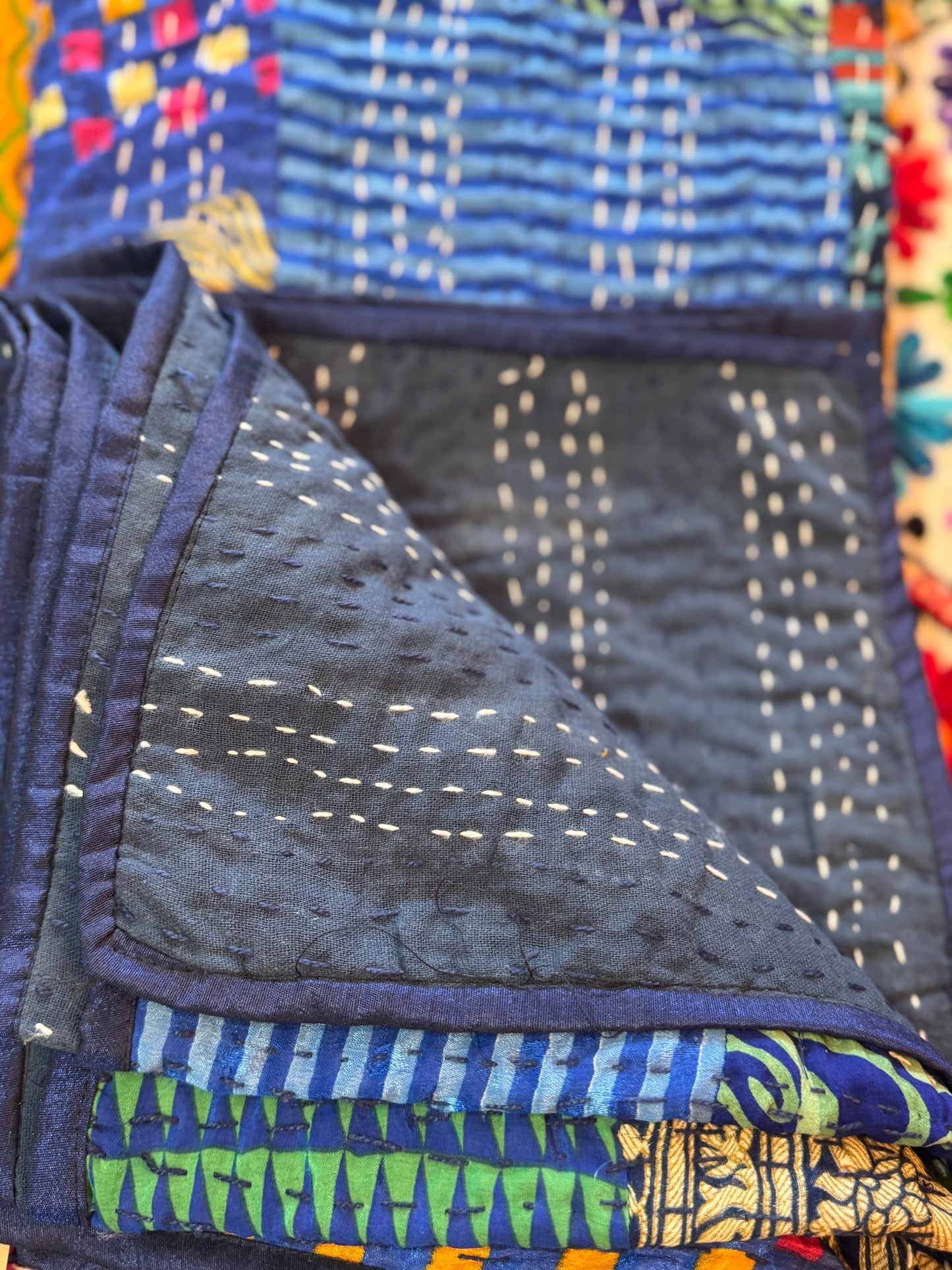 Close-up of a folded fabric with blue and multicolor patterns