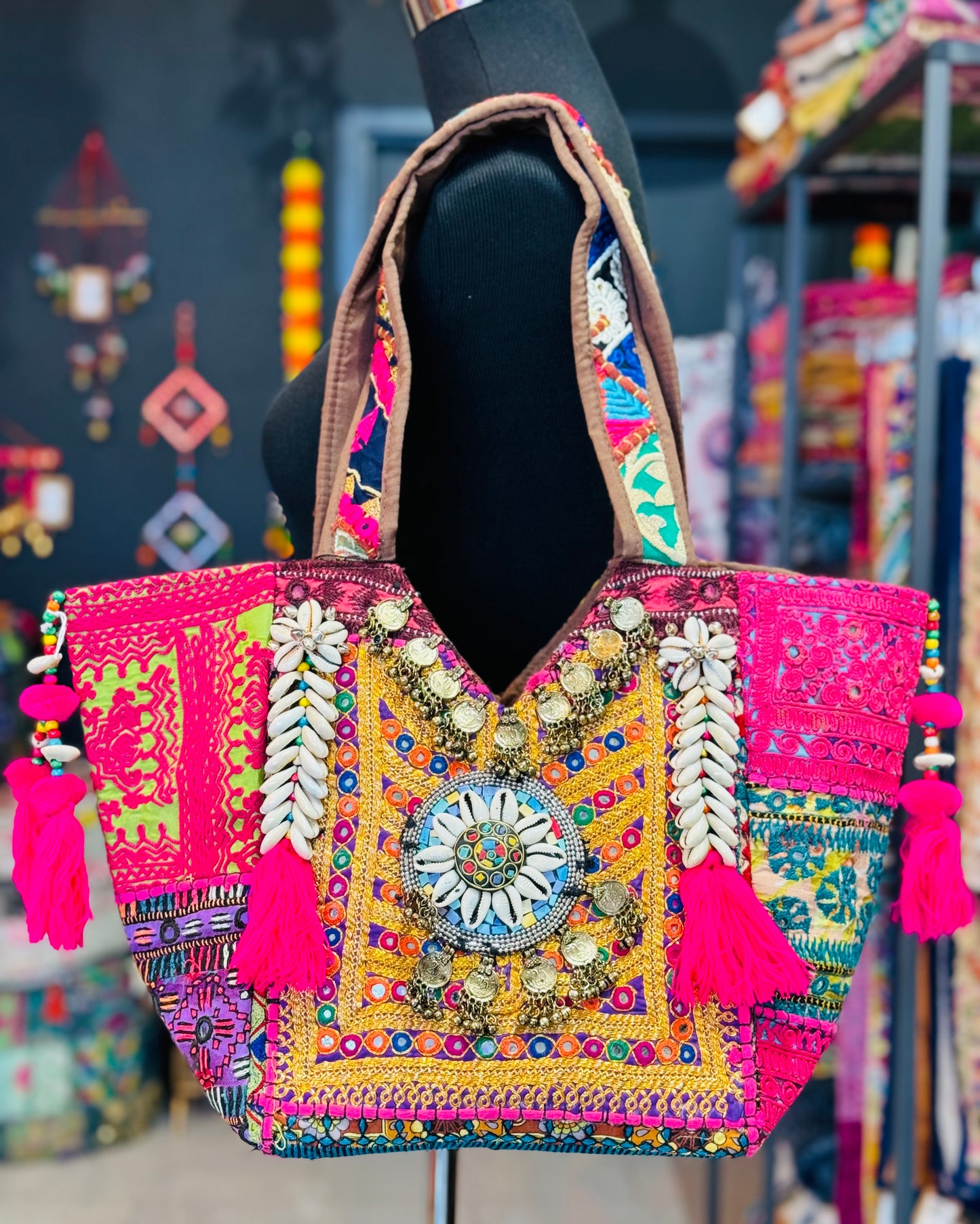 Handamde tribal tote bag in gold, pink and purple tones with shell embellishments, embroidery, and decorative coins