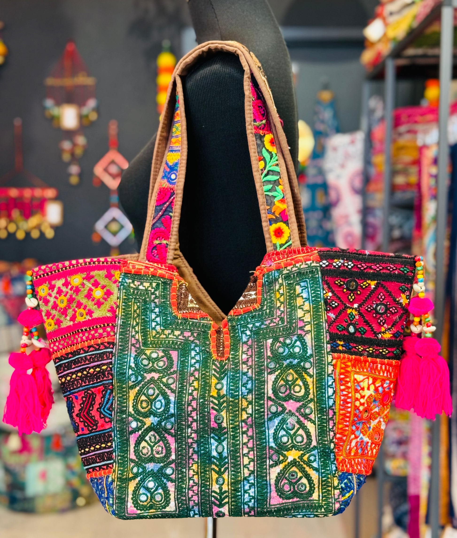 Back side of the Banjara Shoulder Tote Bag with heart shaped embroidered patches in green