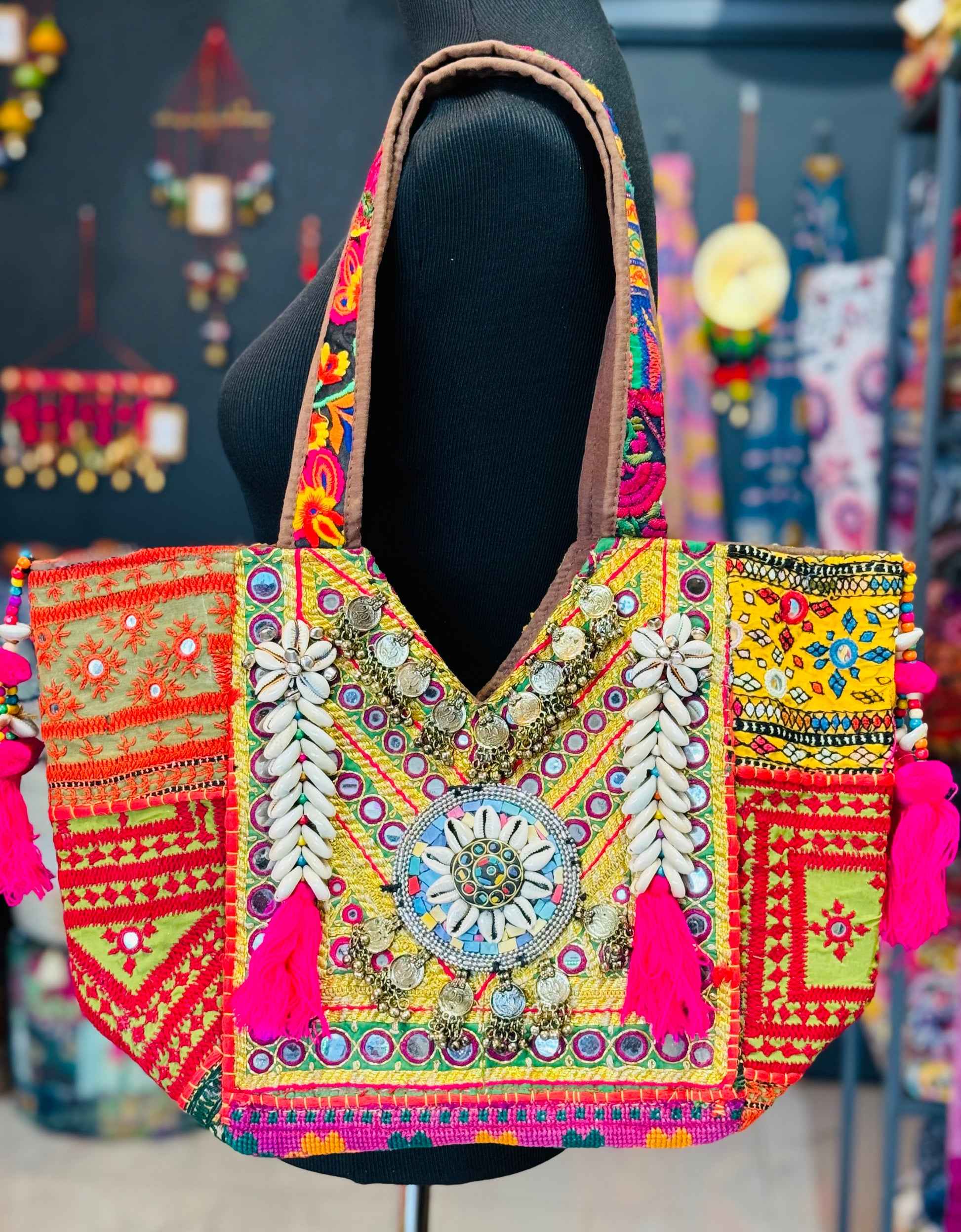 Banjara Boho Tribald Tote Bag with shells, mirrors, indian coins decorated on yellow embroidered oatch with hot pink tassels