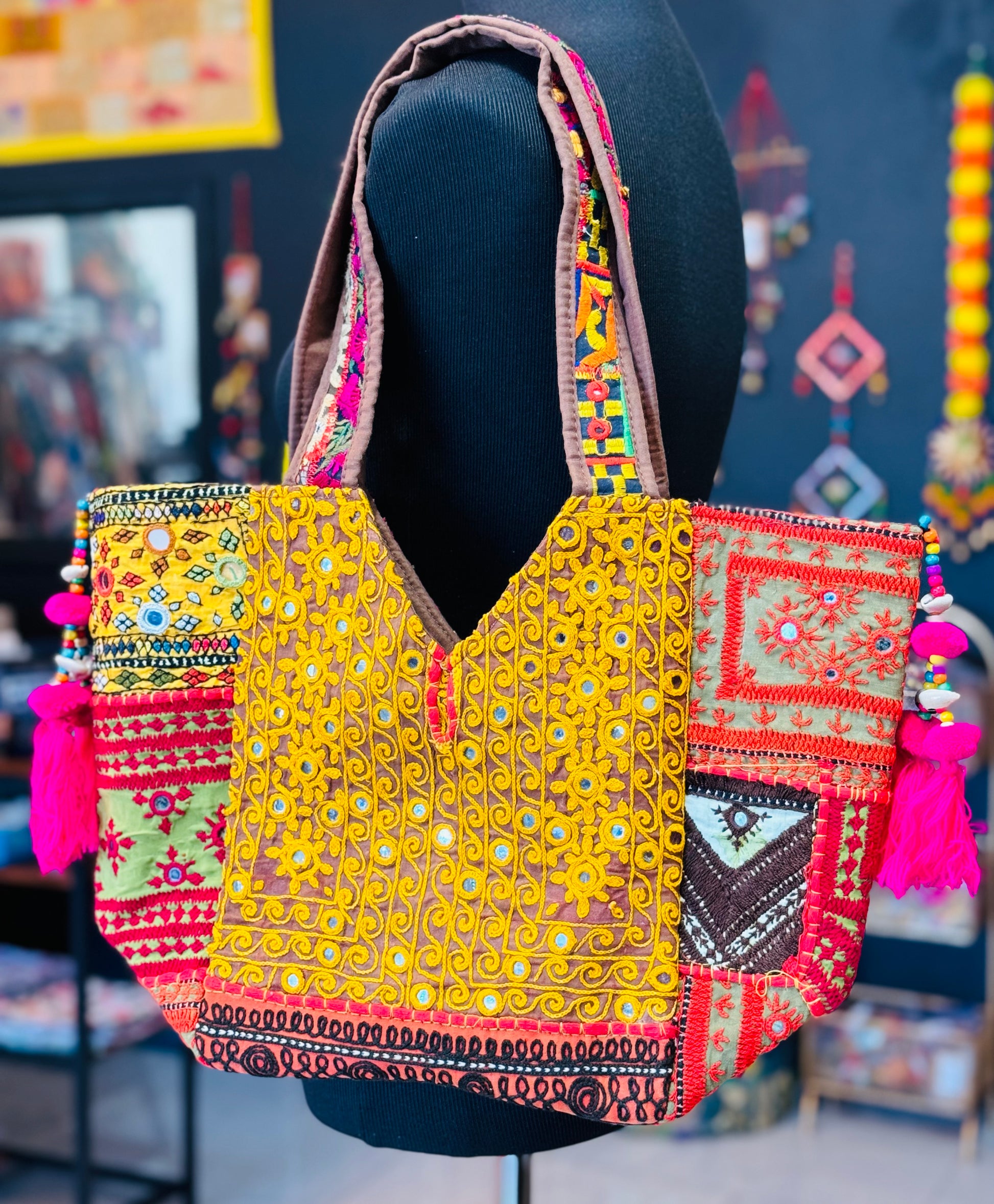 Handmade banjara tote bag backside embroidered in yellow around mirrors