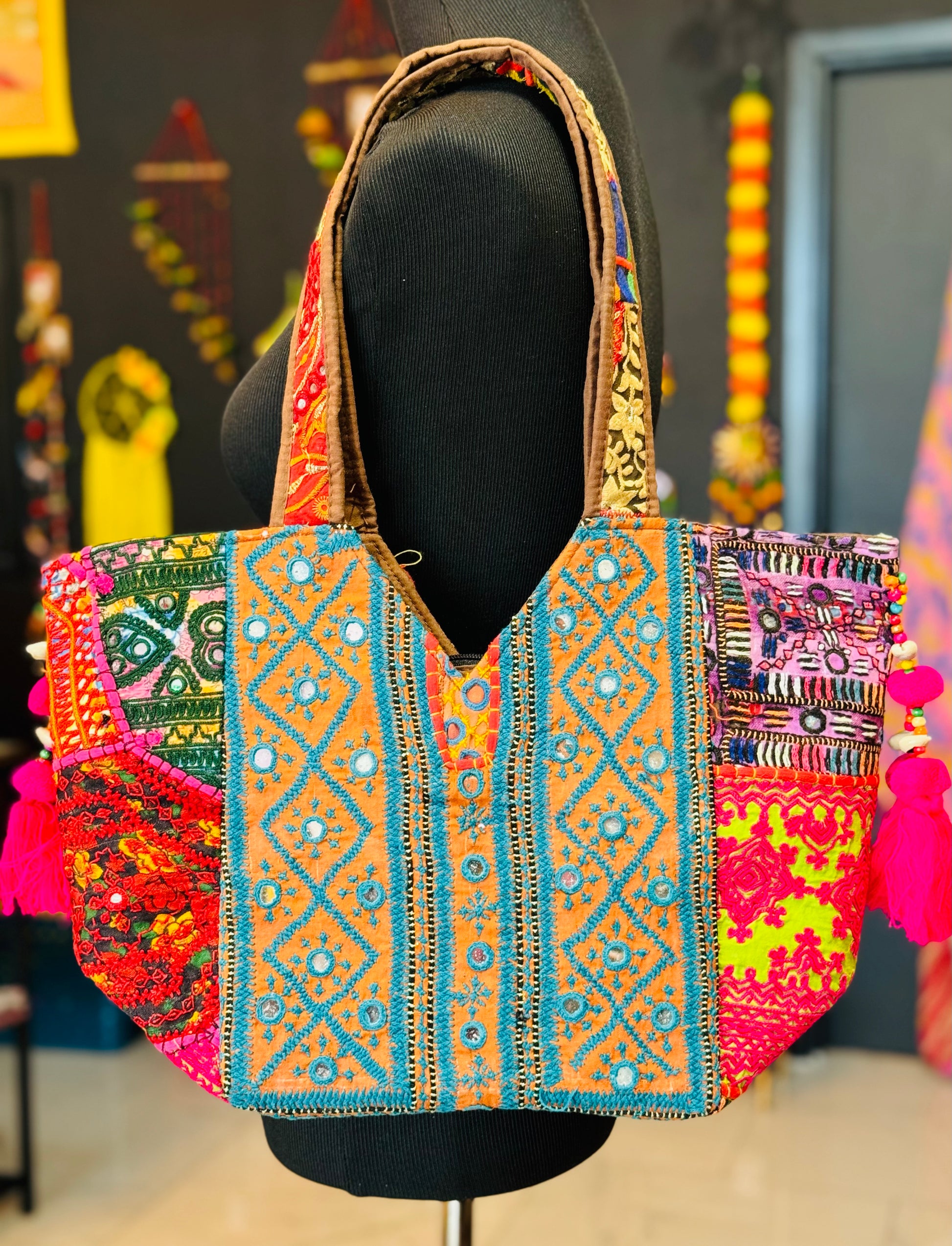 Calm Blue embrioiderey on a yellow patch on this handmade banjara tribal Indian tote bag with multi color embroidered patches with mirror work