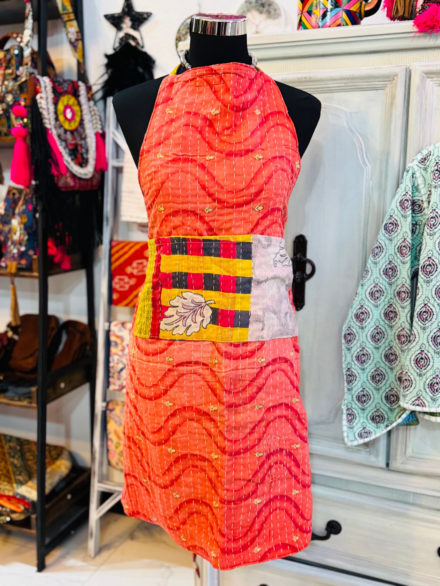 One side of white leaf kantha apron with soft white leaf on the pockets