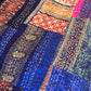 Close-up of a colorful patchwork fabric with intricate patterns.