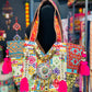Vibrant white banjara tote bag with multi color embroidered patches, mirror work, cowrie shells, hot pink tassels.