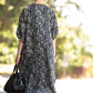 Backside of the white and blace stripes print of Buttons and pockets kaftan dress