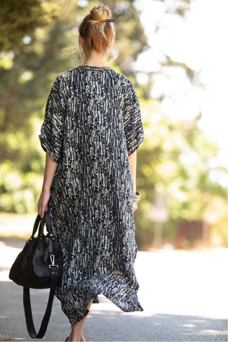 Backside of the white and blace stripes print of Buttons and pockets kaftan dress