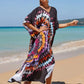 Woman wearing a colorful tie-dye dress on a beach